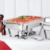 A chafing dish filled with pasta and sauce, placed on a table with salt and pepper grinders. Voir les images du produit