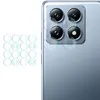 A close-up of a smartphone's camera module with lens protectors laid out next to it. Náhľad obrázku produktu