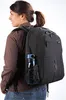 A woman wearing a backpack with a water bottle in the side pocket. Náhľad obrázku produktu