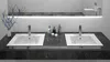 A modern bathroom vanity with two sinks and faucets, reflected in a large mirror above. Náhľad obrázku produktu