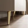 Close-up of the golden legs of a TV cabinet. Náhled obrázku produktu