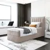 A bedroom scene with a single bed, window, and decorative elements.