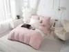 A neatly made bed with pink bedding in a bright, modern bedroom. Podgląd zdjęcia produktu