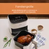 A Cosori air fryer is shown on a white table with a roasted chicken in its basket, along with small bowls of herbs and salt. Náhľad obrázku produktu