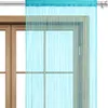 A turquoise string curtain hanging in front of a wooden window frame. Náhled obrázku produktu