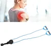 A woman holding her shoulder with a red area indicating pain, and a physical therapy pulley system. Produktbild-Vorschau