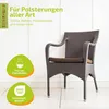 A brown wicker chair with a cushion, placed indoors against a white wall. There are marketing graphics on the left side. Produktbild-Vorschau
