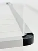A close-up view of a ceiling clothes dryer, showing the corner detail and the hanging rope. Voir les images du produit