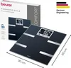 A black diagnostic scale is shown in front of its packaging, with dimensions indicated. Produktbild-Vorschau