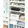 A white shelving unit filled with various office supplies and storage containers. Anteprima dell’immagine prodotto