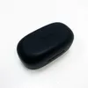 A black TOZO A1 wireless earbud charging case is shown on a white surface. Produktbild-Vorschau