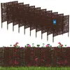 A set of brown woven willow garden borders with pink flowers and green leaves in the foreground, and a white background. Náhled obrázku produktu