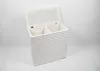 A white, woven laundry hamper with two compartments and an open lid, set against a white background. Podgląd zdjęcia produktu