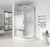 A modern bathroom with a corner shower cabin, a window with trees outside, and bathroom accessories. Anteprima dell’immagine prodotto
