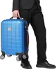 A person in a suit holding a blue suitcase. Anteprima dell’immagine prodotto