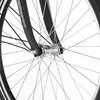 A close-up view of the front wheel and fork of a bicycle. Produktbild-Vorschau
