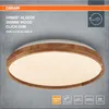 A close-up studio shot of a modern LED ceiling light with a wooden trim, presented against a textured gray background. Produktbild-Vorschau