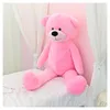 A large pink teddy bear sitting on a white bed with sheer white curtains in the background. Anteprima dell’immagine prodotto