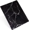 A black cutting board with white marble-like veins, shown at an angle on a white background. Anteprima dell’immagine prodotto