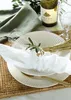 A table setting with plates, cutlery, a napkin, a wine bottle, and glasses. Produktbild-Vorschau