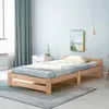 A bedroom scene with a wooden bed frame and bedding. Produktbild-Vorschau