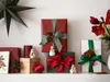 A collection of Christmas gifts and decorations arranged on a shelf. Produktbild-Vorschau