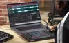 A person is using a laptop and a MIDI controller to create music. Anteprima dell’immagine prodotto