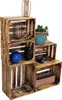 A display of wooden crates stacked in a tiered arrangement, showcasing various decorative items and a plant. Anteprima dell’immagine prodotto