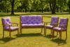 A set of garden furniture with purple cushions placed on a grassy lawn with trees in the background. Anteprima dell’immagine prodotto