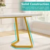 A close-up of a white marble-patterned tabletop with gold metal legs, set in a room with a window and white curtains. Produktbild-Vorschau