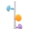 A close-up of a white coat rack with colorful attachments. Anteprima dell’immagine prodotto
