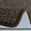 A close-up view of a brown carpet with a brown binding. Anteprima dell’immagine prodotto