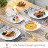 A table setting with multiple plates of food, cutlery, and a drink, arranged on a wooden table with a decorative runner. Produktbild-Vorschau