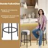 A woman is sitting on a bar stool in a modern kitchen setting, with a close-up of the stool's base on the left. Podgląd zdjęcia produktu