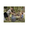 A family is having a picnic by a lake, with a tent set up nearby. Produktbild-Vorschau