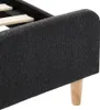 Close-up view of the side and leg of a dark gray fabric bed frame. Podgląd zdjęcia produktu