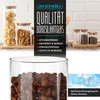 A close-up of glass storage jars filled with food items, with marketing text and product features listed on the side. Produktbild-Vorschau