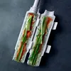 A sushi-making tool with ingredients inside, placed on a dark gray surface. Náhled obrázku produktu