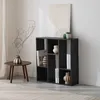 A black bookshelf with books and decorative items in a room. Produktbild-Vorschau