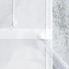 A close-up view of a white fabric curtain or blind, showing a drawstring with a clear bead and a clear plastic tube inserted into a hem. Produktbild-Vorschau