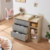 A baby changing table with drawers and shelves in a nursery room. Produktbild-Vorschau