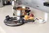 A REMOSKA electric baking pot with a lid removed, filled with apple slices, sits on a kitchen counter next to apples, cinnamon sticks, cloves, and a cup of coffee. Anteprima dell’immagine prodotto