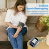 A young woman is using a blood pressure monitor while sitting on a couch. Produktbild-Vorschau