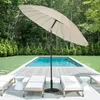 An outdoor patio scene with a swimming pool, lounge chairs, and a large umbrella. Anteprima dell’immagine prodotto