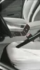 A close-up view of a car interior, showing a vacuum cleaner nozzle being used to clean a car seat. Podgląd zdjęcia produktu