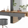 A vanity table with a mirror, drawers, and decorative items on top, along with a stool. Anteprima dell’immagine prodotto