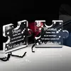 Two clear acrylic puzzle pieces with engraved text and decorative elements, placed on a reflective surface with a dark background and a red rose. Náhľad obrázku produktu