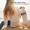 A person and a dog sit by the sea, with the person wearing a phone case with a lanyard. Produktbild-Vorschau