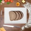 A cutting board with slices of bread on it, surrounded by ingredients and kitchen utensils. Produktbild-Vorschau
