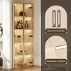A tall, narrow glass display cabinet with LED lighting, showcasing various items on its shelves. The right side of the image features close-up marketing graphics highlighting safety features and integrated lighting. Produktbild-Vorschau